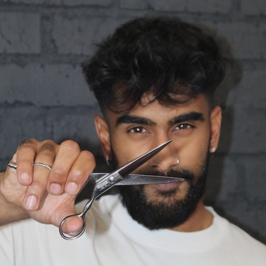 Eastside Barbers barber with shears